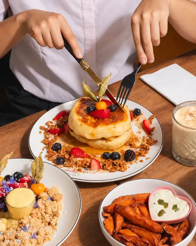 Cutting into the soufflé Ruby Pancake at brunch